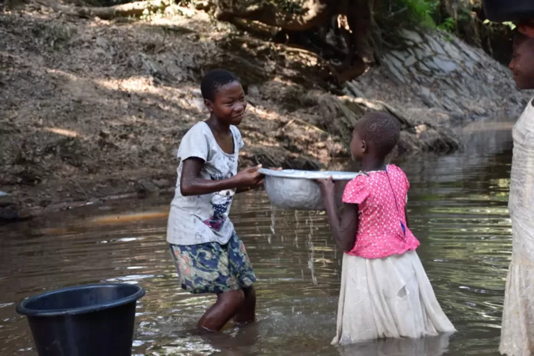 Girls Gathering Water Together